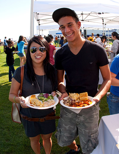 Photo of students getting food at the Dining tents for a picnic dinner at Cornucopia event