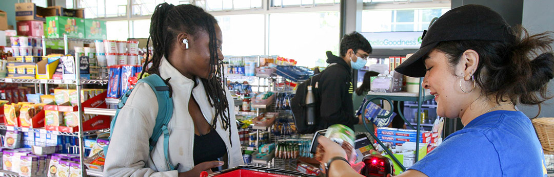 Student checking out at the Merrill Market cashier