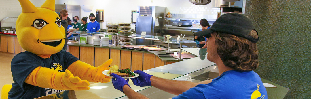 Sammy Slug getting food in a UCSC dining hall