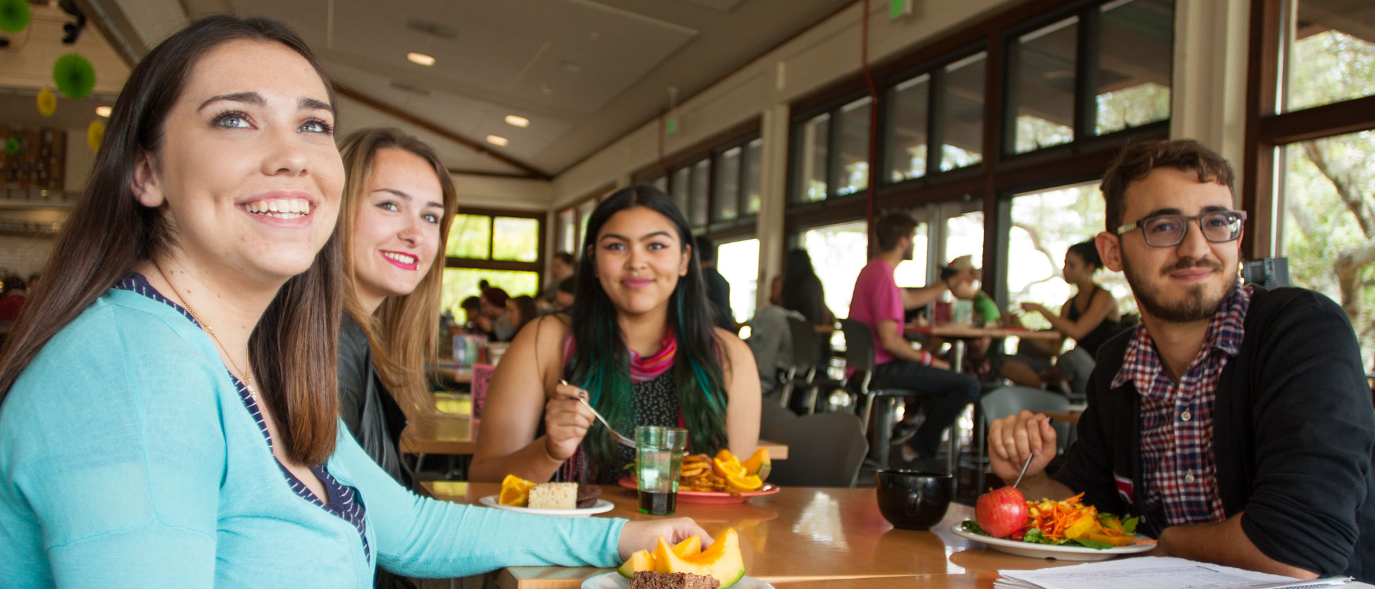 Four students eating at Cowell/Stevenson Dining Hall